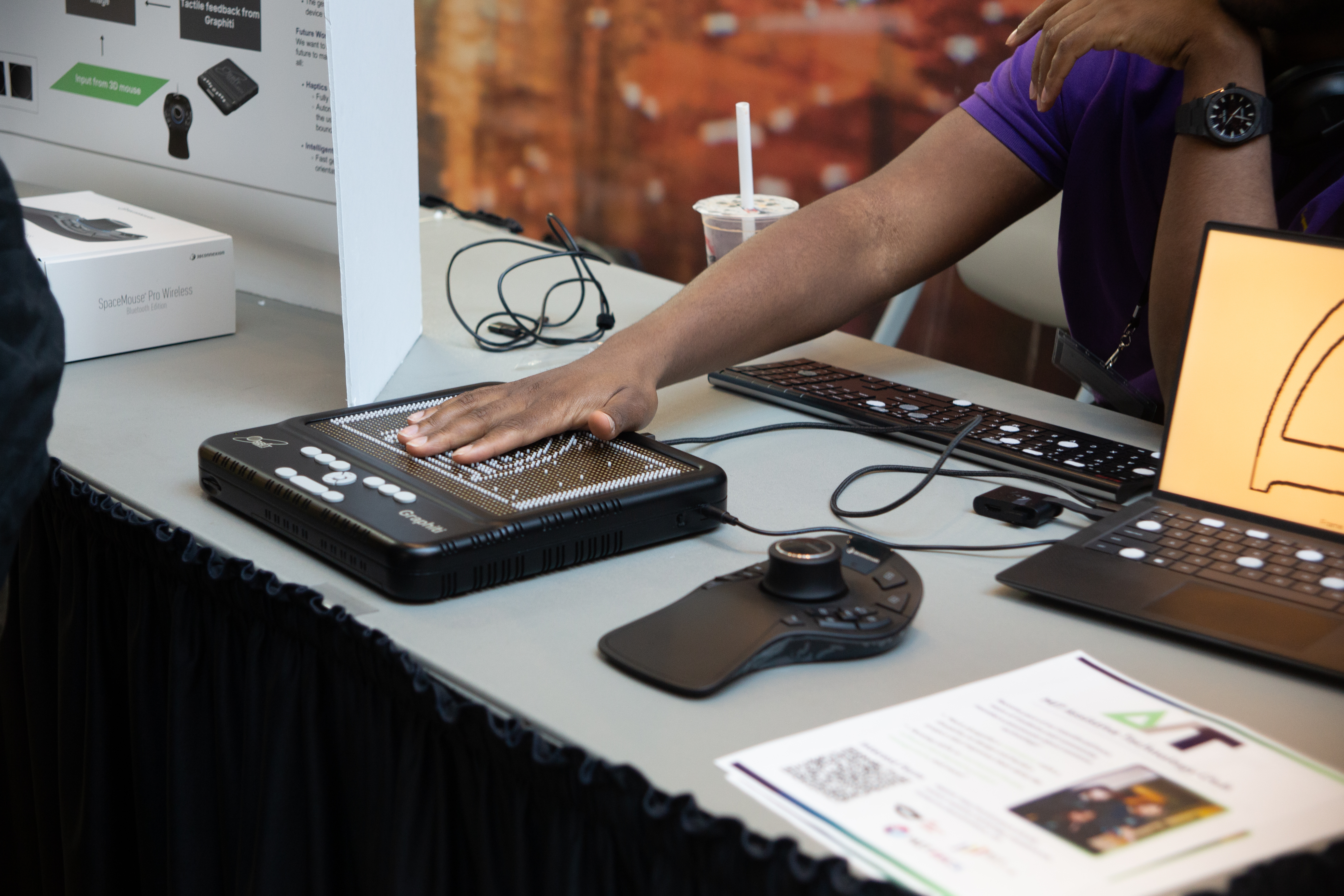 The 3D Tactile Access team visualizes 3D CAD models on a Graphiti board! A hand reaches out to feel a tactile board (Graphiti) that displays the cross-section of a 3D CAD model.